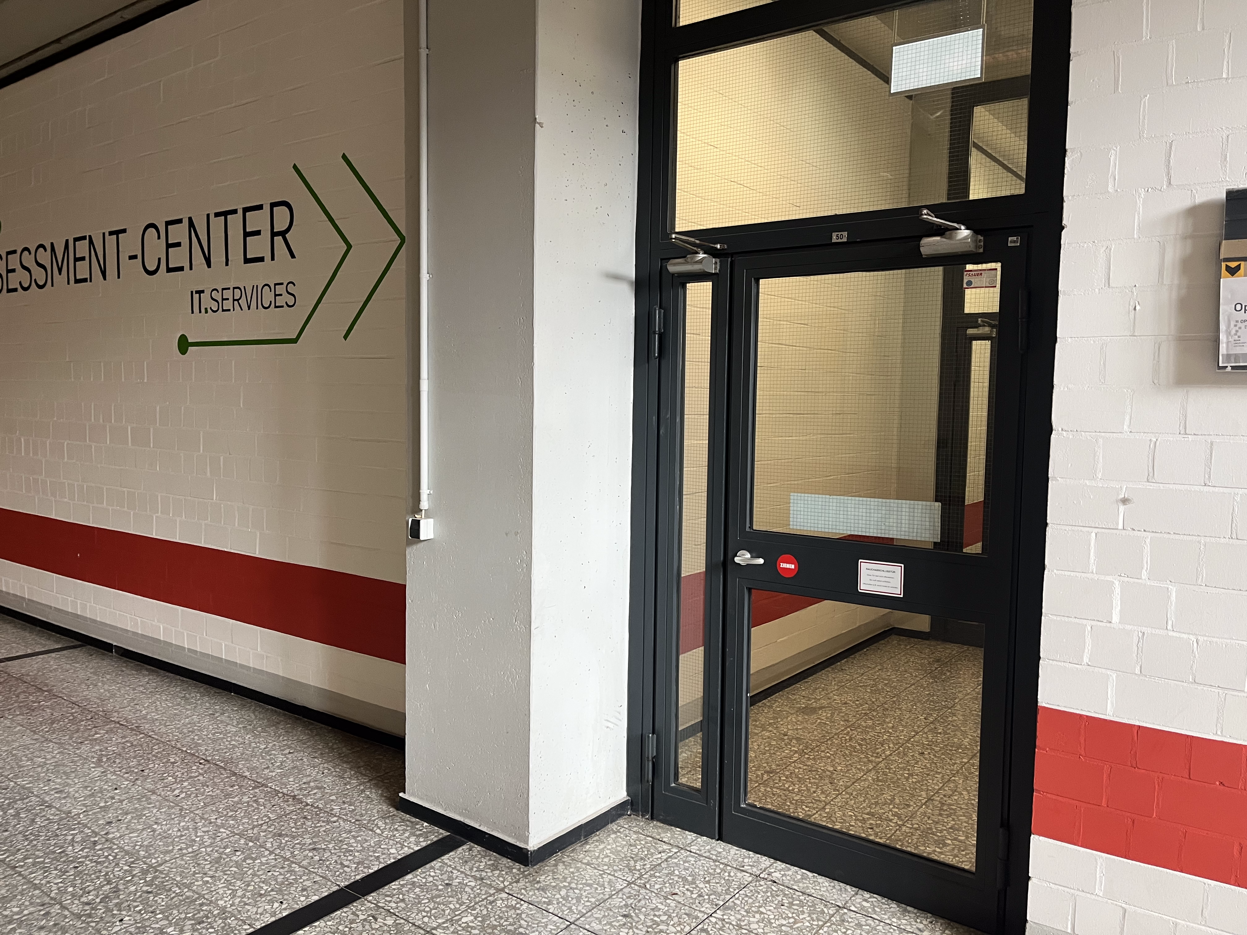 Die Tür rechts neben dem E-Accessment-Center Logo